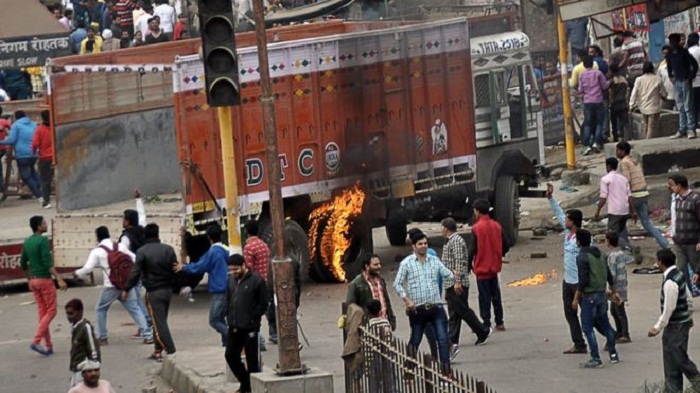 India Jat protests: Curfews after caste violence flares